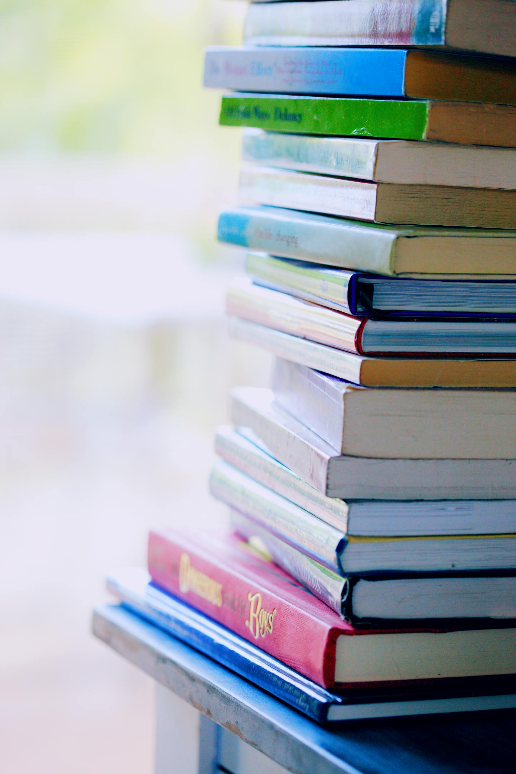 Selective Focus Photo of Pile of Assorted-title Books